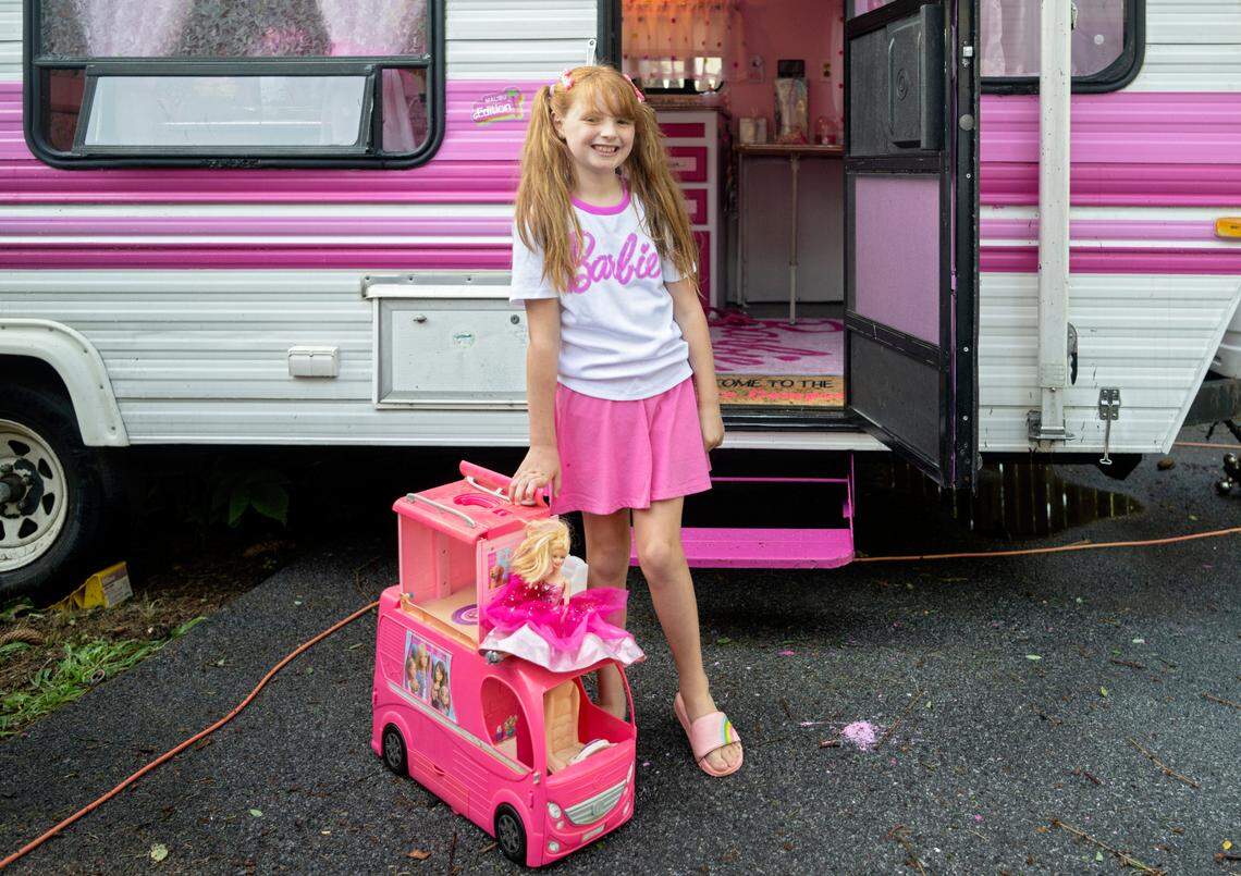 Jazmyn “Jazzy” Krammes with her toy Barbie camper outside of her family’s real life Barbie camper.