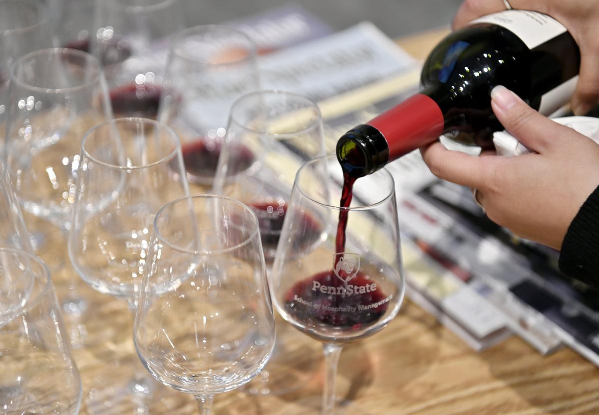 Doctoral candidate Anqi Luo pours classes of a 2016 Malbec for students to sample in the Penn State Wine Appreciation class on Thursday.