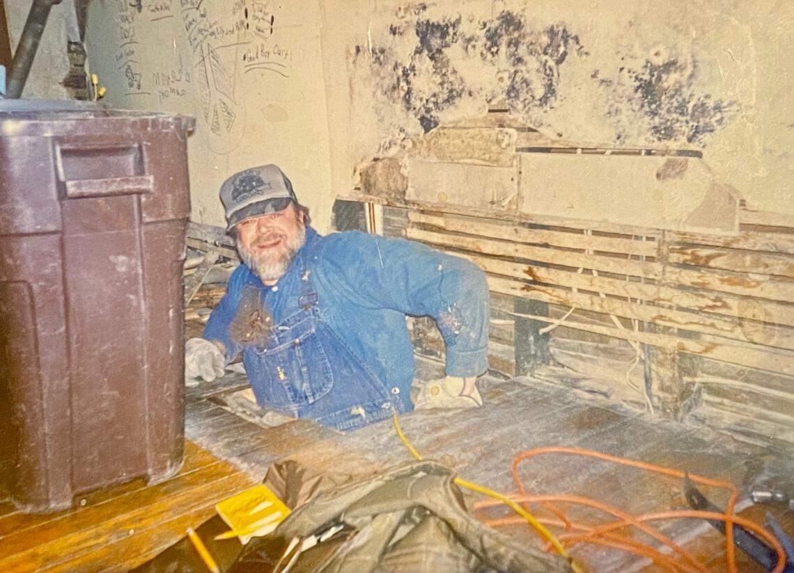 Curtis Miller, Nancy Noll’s husband, in the dining room before renovations at the The Queen, A Victorian Bed and Breakfast.