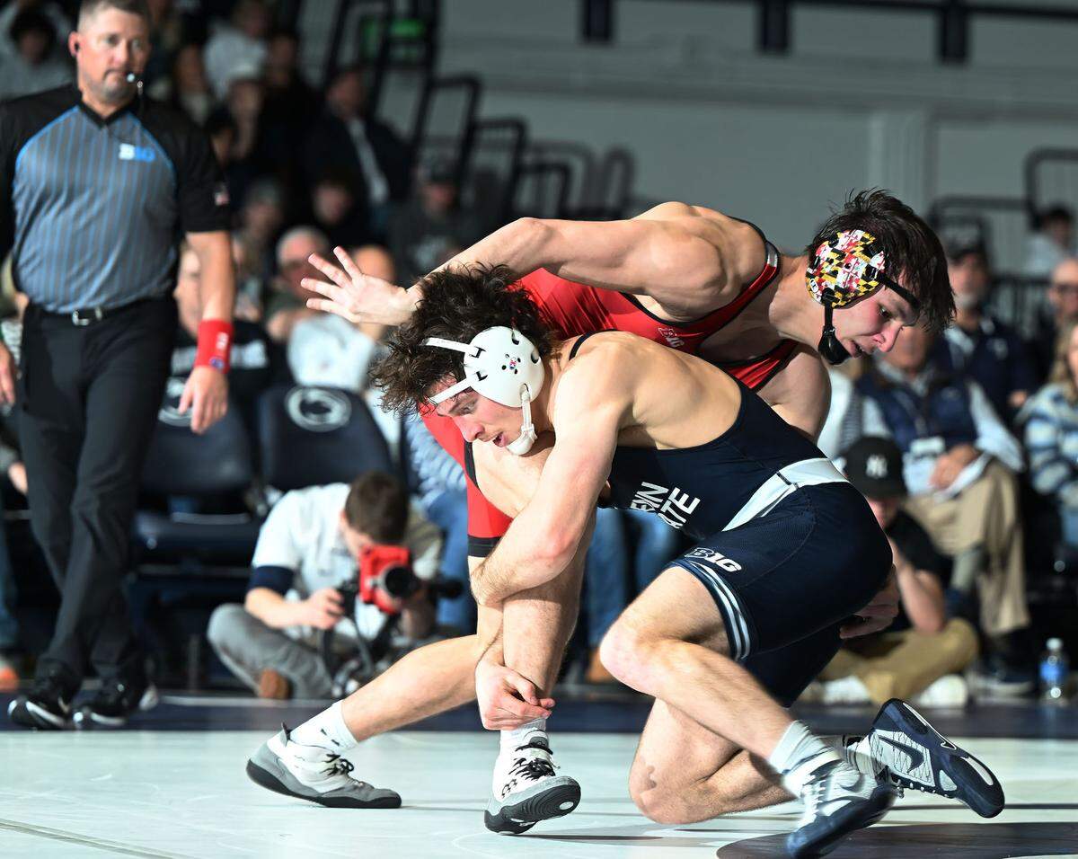 Penn State’s Levi Haines drives Maryland’s Branson John to the mat at 174 lbs. during Sunday’s meeting at Rec Hall in State College. Haines defeated John, 8-1.