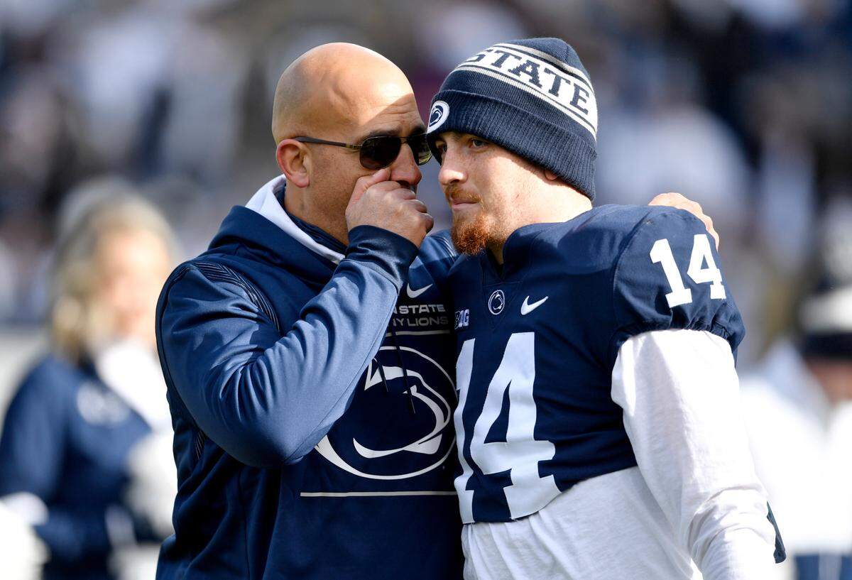 Penn State football coach James Franklin congratulates quarterback Sean Clifford during the senior day celebrate before the game against Rutgers on Saturday, Nov. 20, 2021.