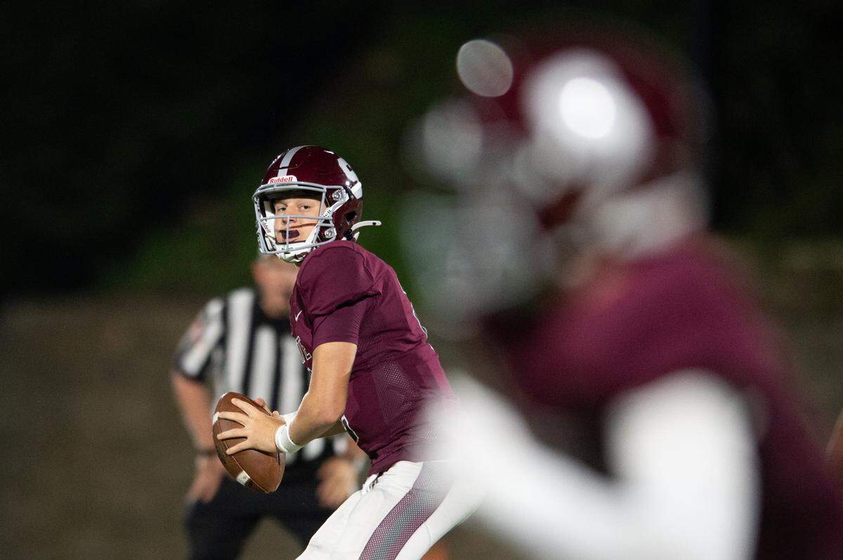 State High quarterback Eddie Corkery looks to pass the ball during the football game at Memorial Field on Friday, Oct. 4, 2024.