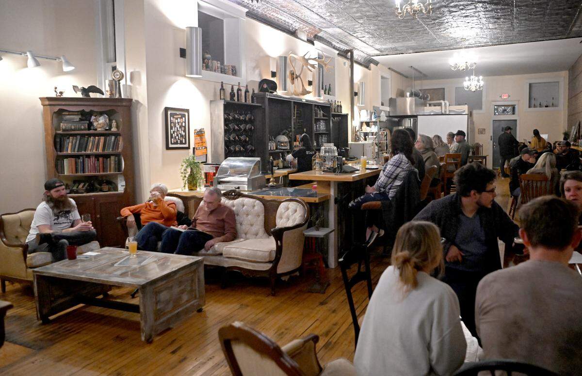 Patrons enjoy drinks and music at the Dead Canary Brewing Company in Philipsburg on Oct. 19, 2023.