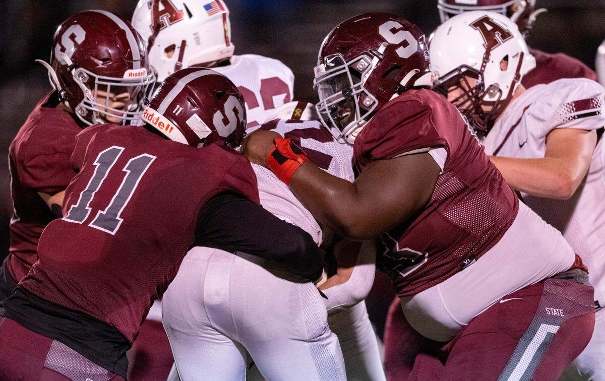 State College’s John Scott (11) and Justin Castro stop Altoona’s Alex Yost during the District 6 6A championship game at Bald Eagle Area on Thursday, Nov. 10, 2022. State College won, 28-7.