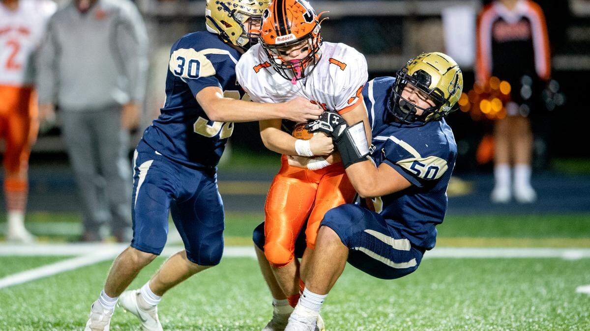 Bald Eagle Area’s Tanner Bower and Hunter McCool stop Jersey Shore’s Elijah Jordan during the game on Friday, Oct. 22, 2021.