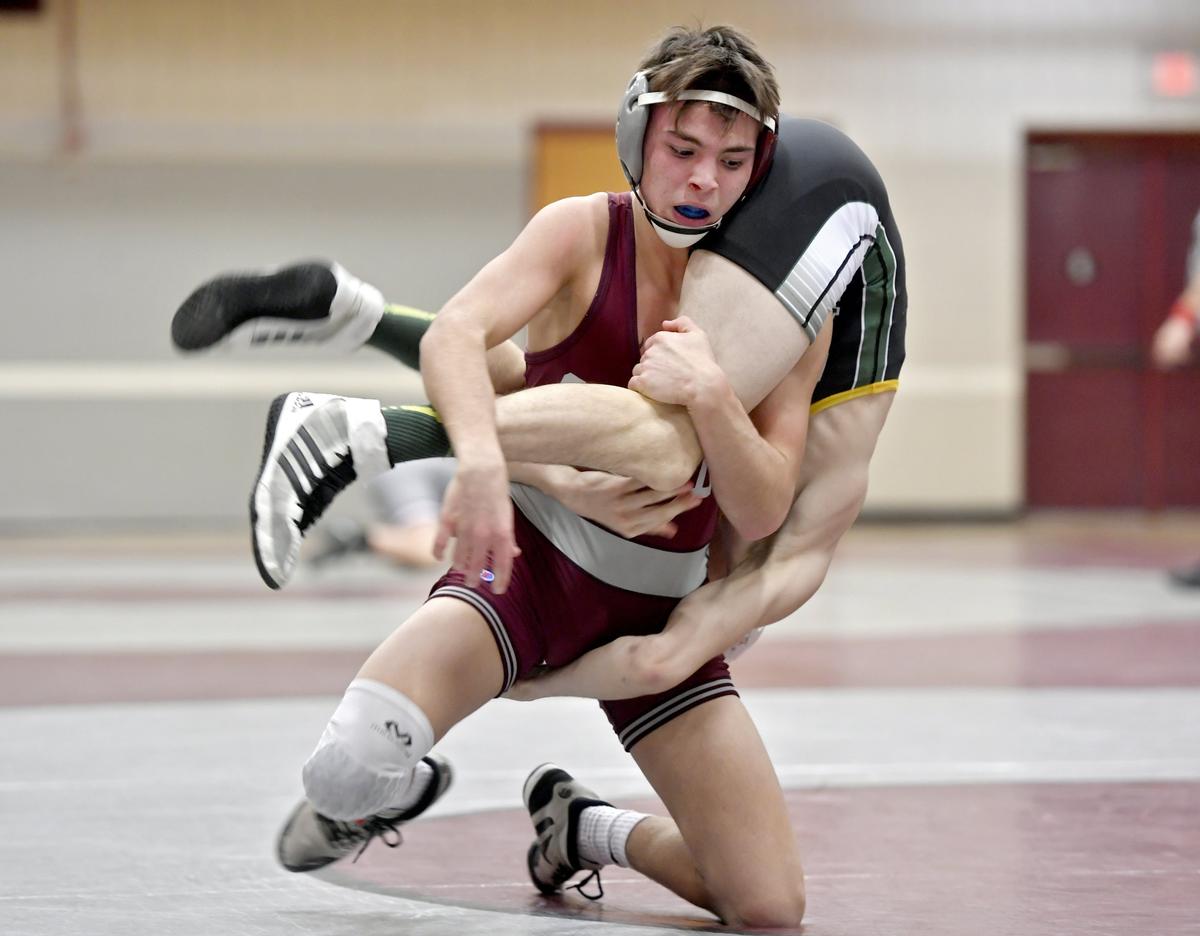 State College’s Clayton Liedy controls Carlisle’s Seth Bloomquist in the 120 bout during the match on Monday, Feb. 4, 2019.