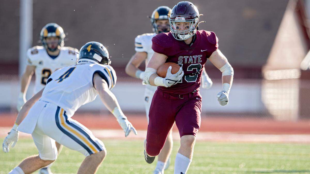 Mt. Lebanon defenders try to stop State College’s Brady Bendik as he runs down the field with the ball during the PIAA class 6A semifinal game on Saturday, Dec. 4, 2021 at Mansion Park. Mt. Lebanon won, 49-28.