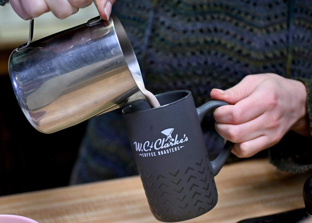 Zoe Ellis pours a hot chocolate at The Cheese Shoppe on Monday, Feb. 10, 2025.