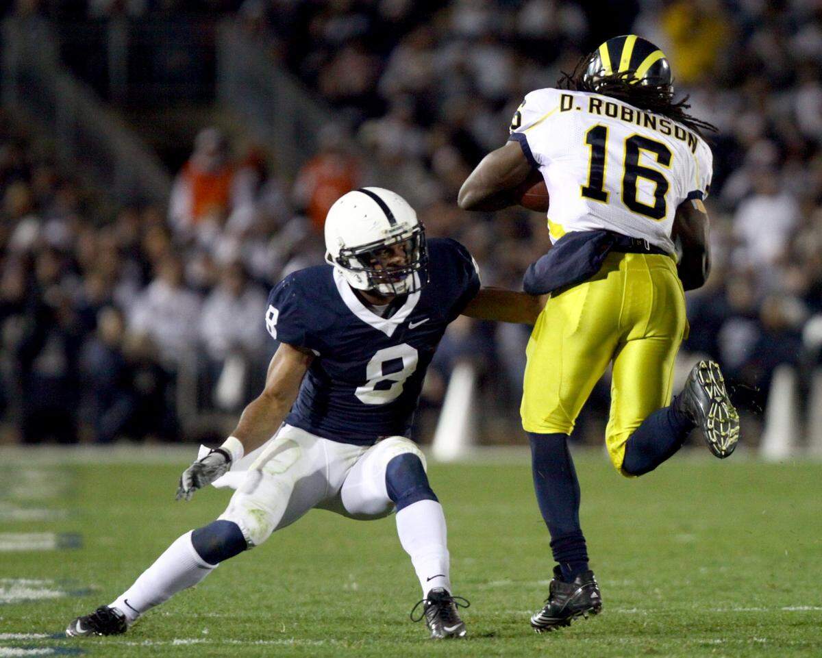 Penn State’s D’Anton Lynn reaches to stop Michigan’s Denard Robinson on Saturday, October 30, 2010.