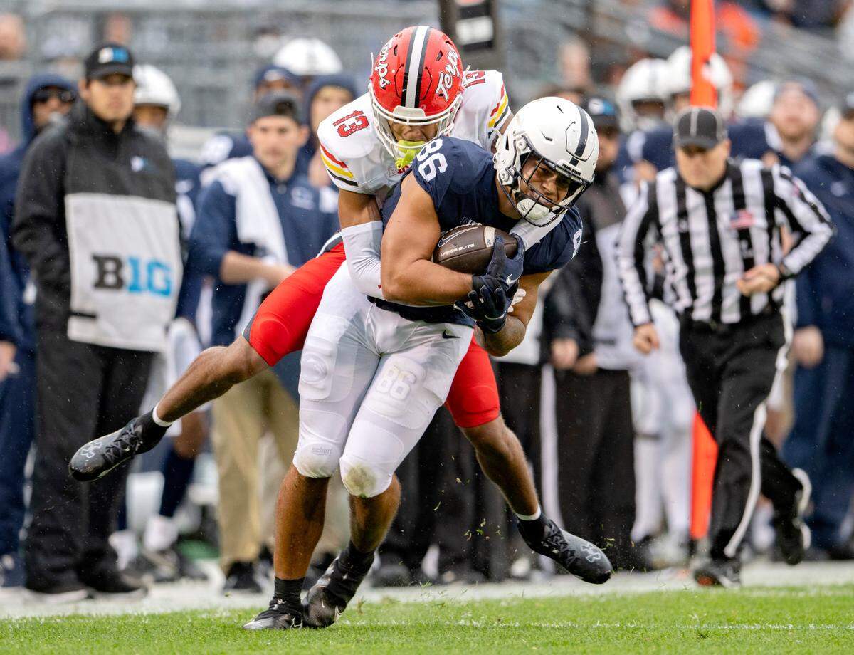 Maryland’s Glendon Miller tries to stop Penn State tight end Brenton Strange after he makes a catch during the game on Saturday, Nov. 12, 2022.