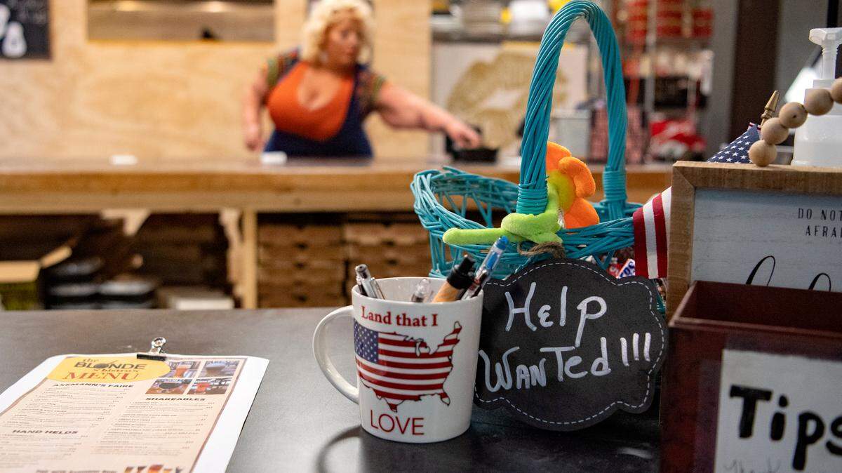 A “Help Wanted” sign sits on the counter at Blonde Bistro on Friday as owner Ciara Semack receives orders.