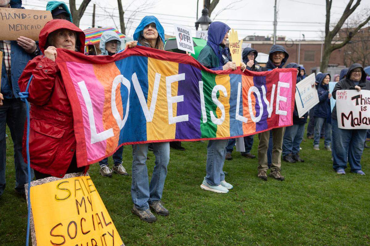 Protesters hold signs Saturday while listening to speakers at the “Hands Off!” rally at State College’s Sidney Friedman Park, in opposition of President Donald Trump. The event was part of a nationwide effort that saw more than 1,000 similar rallies held across all 50 states.