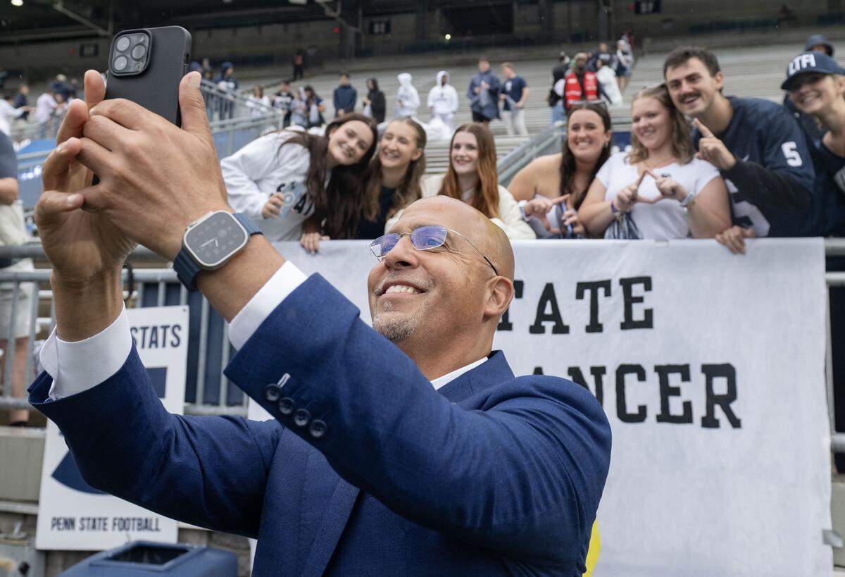 Penn State football coach James Franklin takes a selfie with students and their Thon banner before the game against FIU on Saturday, Sept. 6, 2025 at Beaver Stadium.