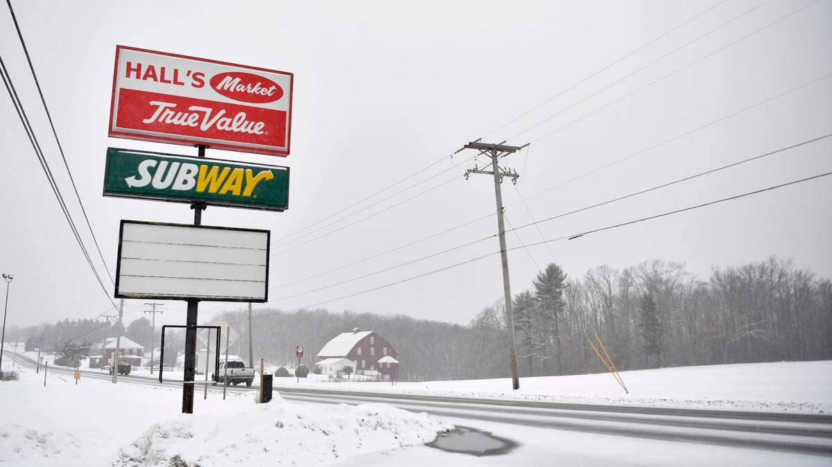 Cars travel past the sign for the old Hall’s Market, True Value and Subway that have closed in Snow Shoe on Friday, Jan. 28, 2022.