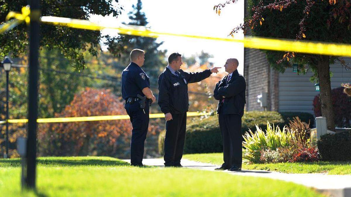 Officers talk outside of a townhome on Gerald Street in College Township while investigating a stabbing on Monday, Oct. 26, 2015.
