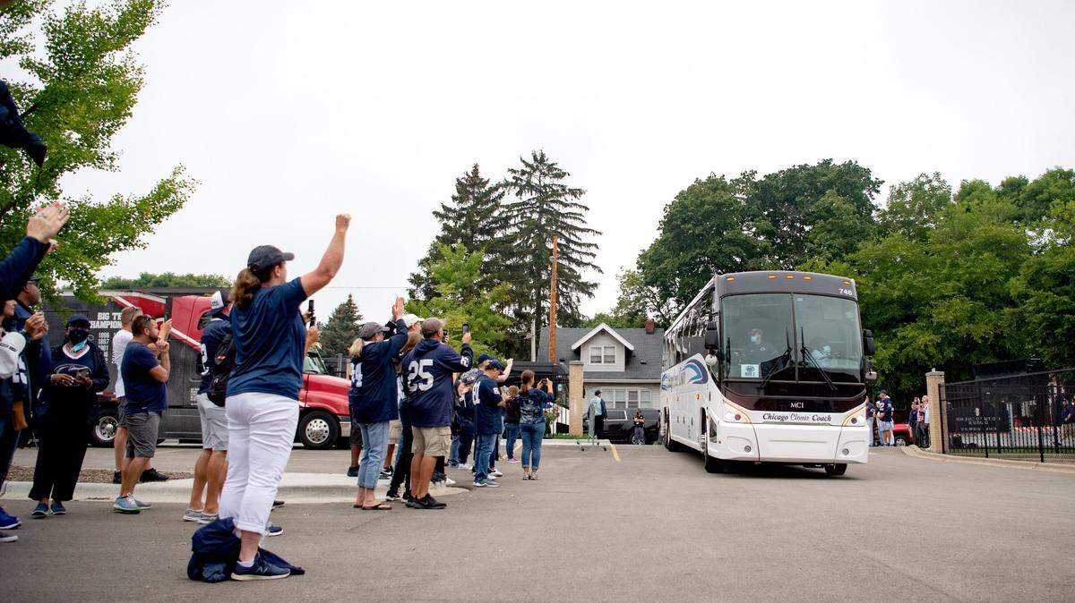 Penn State football fans greet the team bus as players and coaches arrive at Camp Randall Stadium in Madison, Wisconsin on Saturday, Sept. 4, 2021.