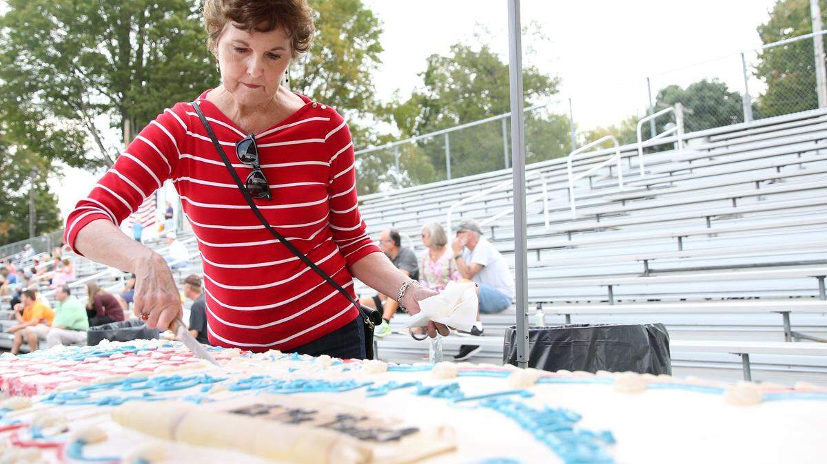 Diane Ebken cuts the cake during the Constitution Celebration in September at Grange Park.