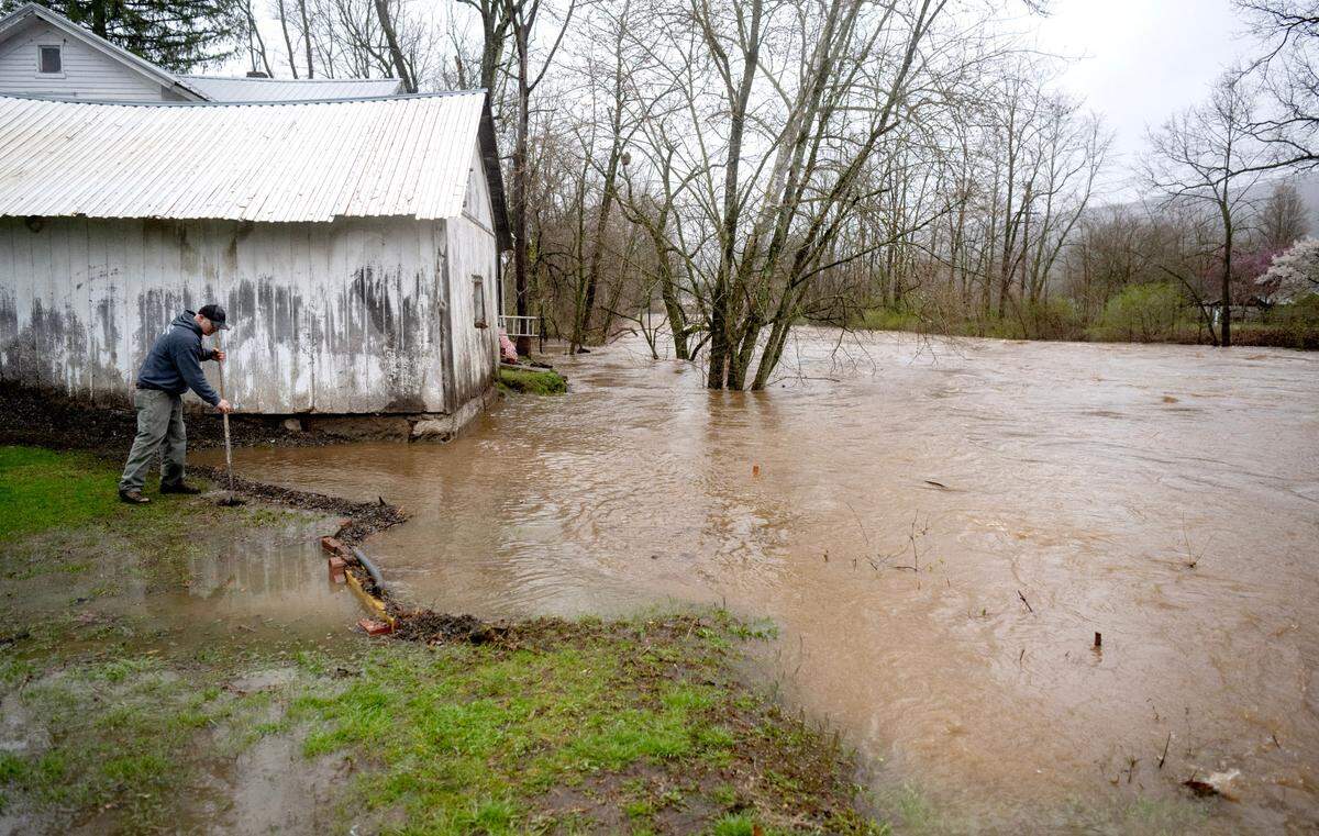 Moose Run starts to encroach houses along Front Street in Milesburg on Wednesday, April 3, 2024.