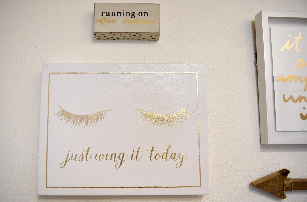 Artwork about eyelashes, love and positivity hangs on the walls of Winged Beauty Studio in Bellefonte on Thursday.
