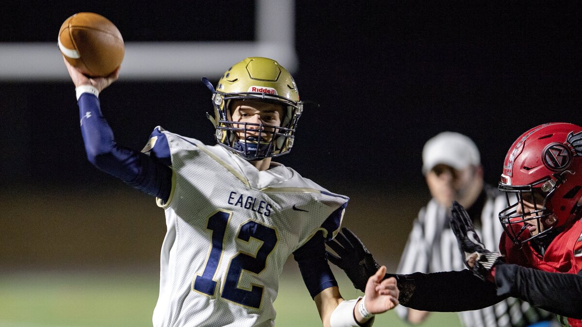Bald Eagle Area’s Jaden Jones makes a pass before being hit by Bellefonte defenders during the Curtin Bowl on Friday, Oct. 26, 2018.