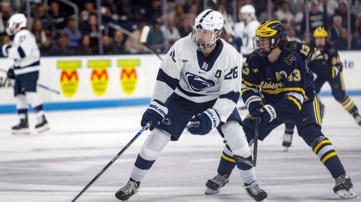 Penn State’s Tyler Gratton skates down the ice with the puck ahead of a Michigan defender during the game on Friday, Nov. 4, 2022 at Pegula Ice Arena.