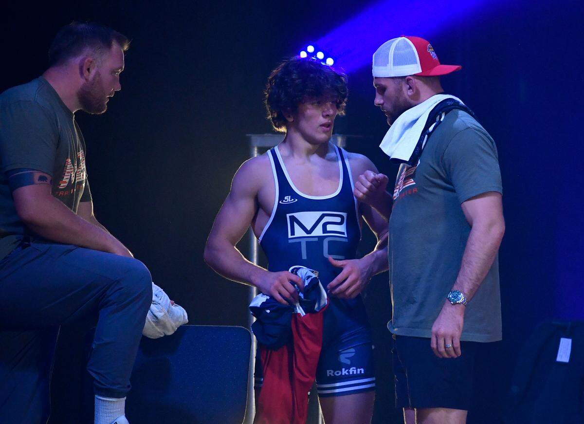 Levi Haines talks to coach David Taylor after his bout Andy Troczynski against in the match between Apex and M2 Training Center at C3 Sports on Wednesday, June 16, 2021.