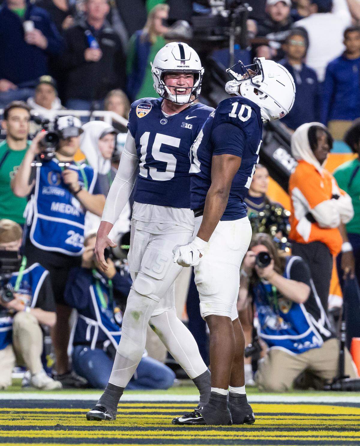 Penn State Nittany Lions running back Nicholas Singleton (10) celebrates with quarterback Drew Allar (15) after scoring a touchdown against the Notre Dame Fighting Irish in the first half of their NCAA Playoff Semifinal Capital One Orange Bowl football game at Hard Rock Stadium on Thursday, Jan. 9, 2025, in Miami Gardens, Fla.