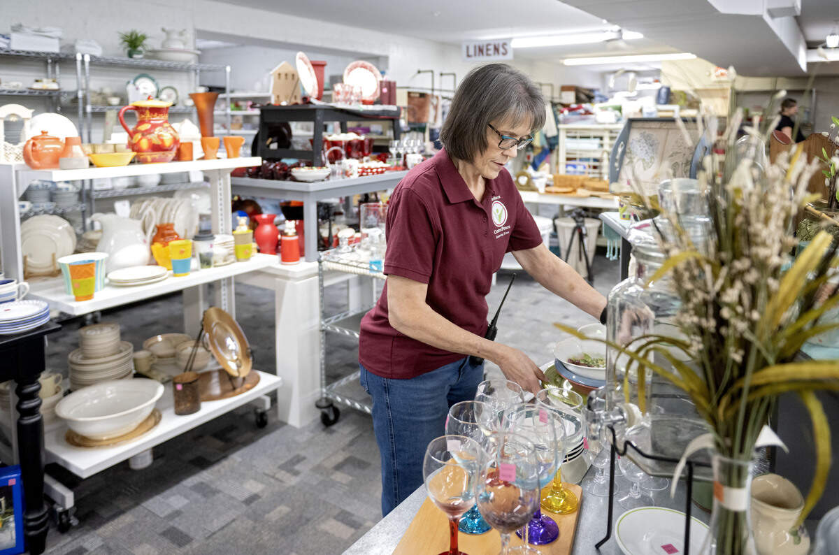 Centre Peace executive director Barbara Squires reorganizes a display in the second floor showroom on Thursday, June 25, 2026.