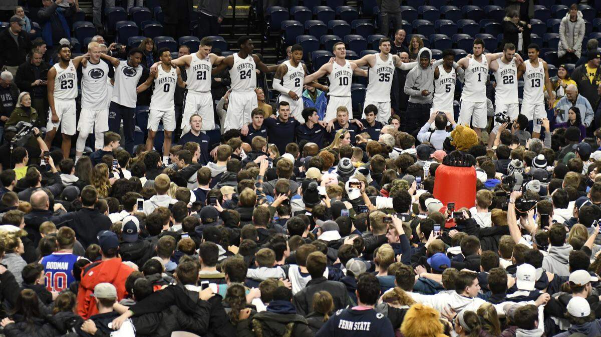 Penn State players celebrate their 75-69 upset win over Michigan in an NCAA college basketball game, Tuesday, Feb. 12, 2019, in State College, Pa. (AP Photo/John Beale)