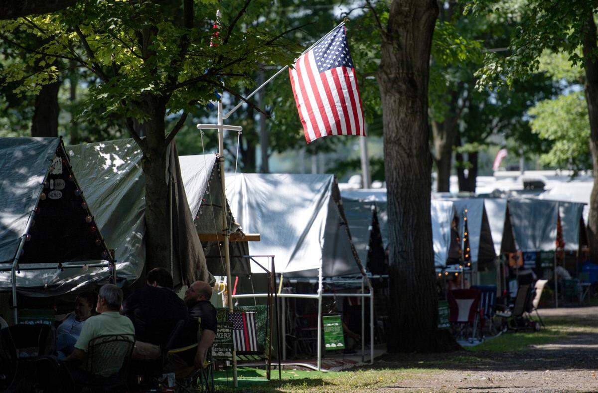 An American flag waves in the breeze from a tent at the Centre County Grange Fair on Tuesday.