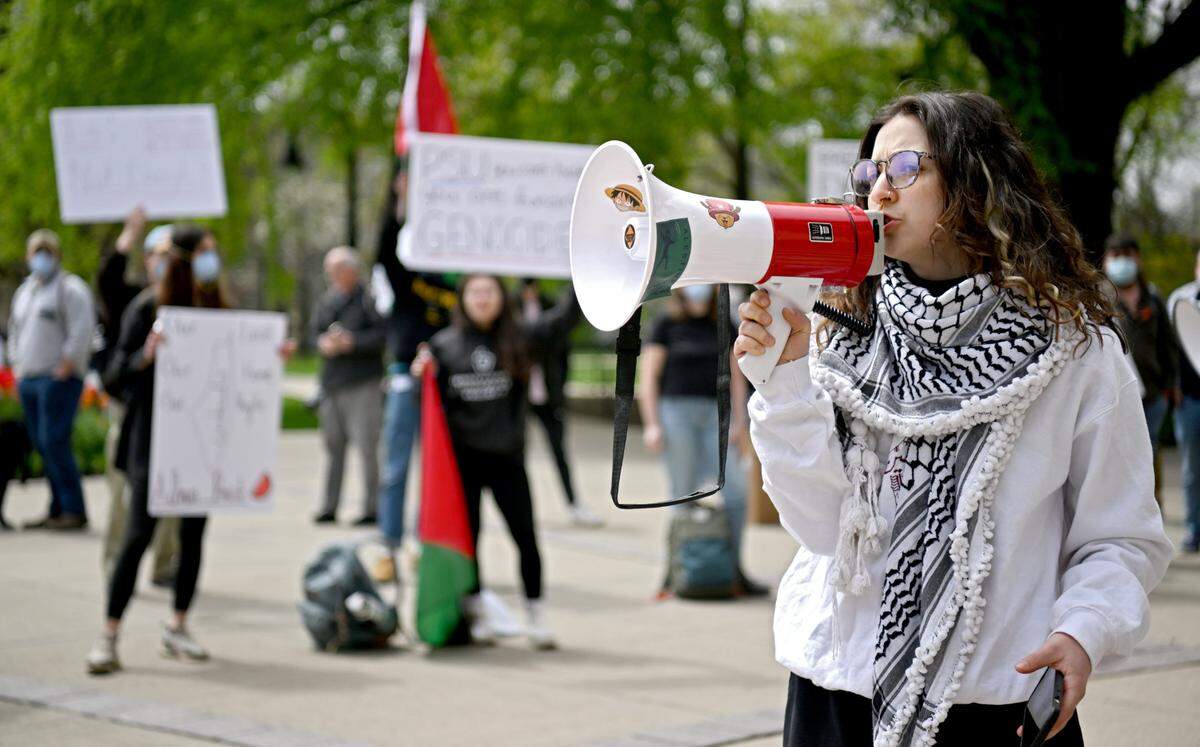 Penn State student Roua Daas speaks to the crowd outside of Old Main as they rally in support of Palestine and to call on Penn State to divest from Israel on Thursday, April 25, 2024.