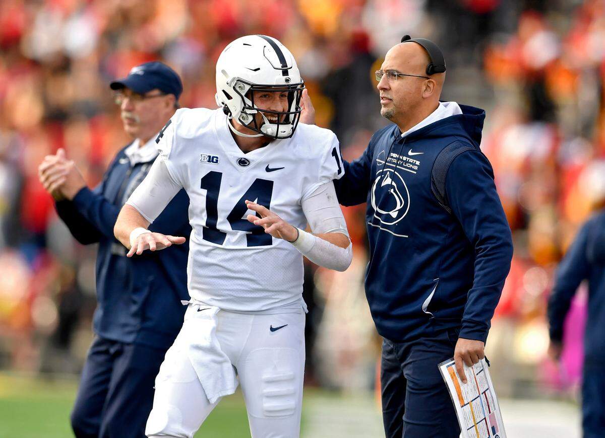 Penn State quarterback Sean Clifford and coach James Franklin celebrate after a touchdown and field goal during the game against Maryland on Saturday, Nov. 6, 2021.
