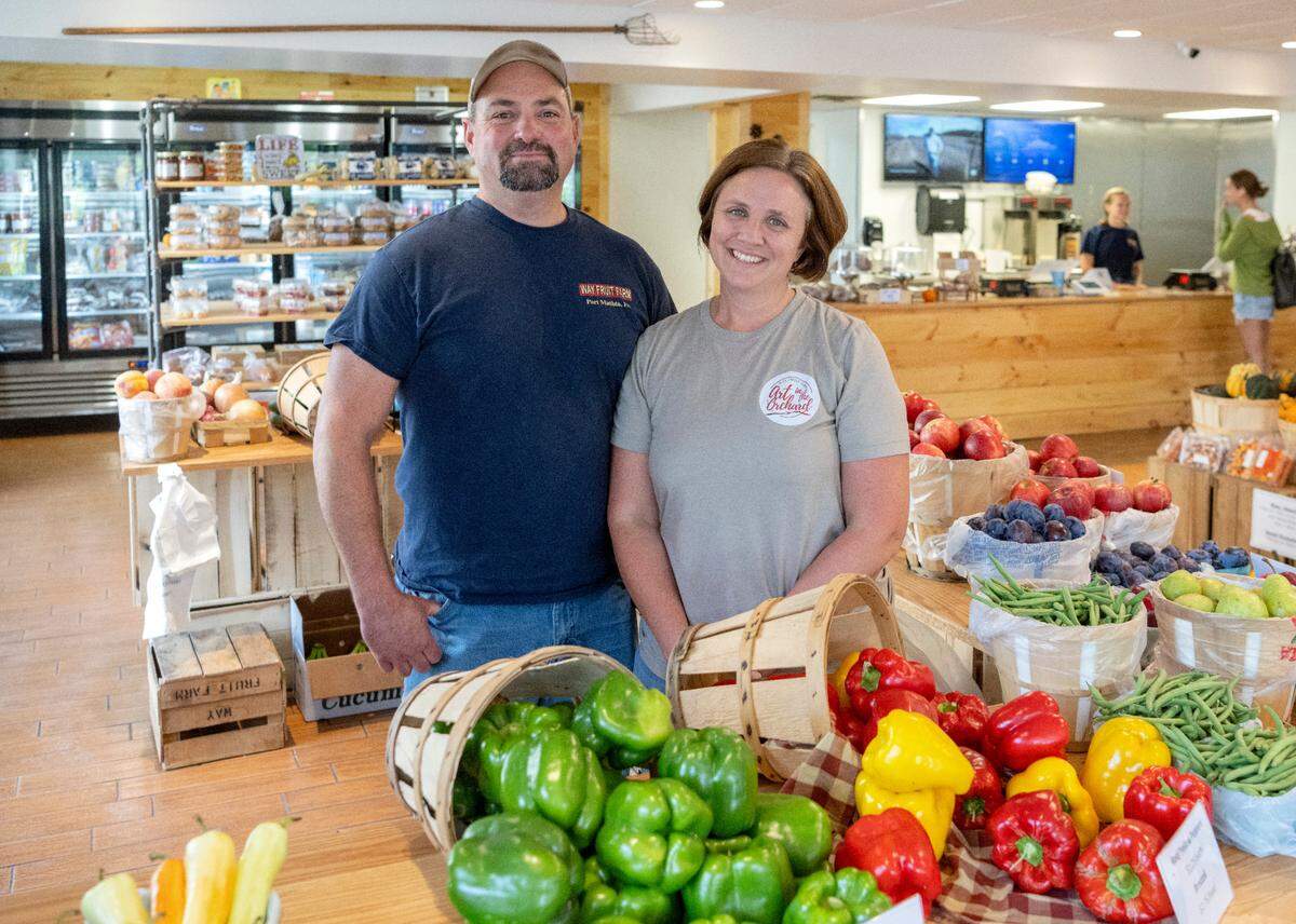 Jason and Megan Coopey of Way Fruit Farm pose in the new downtown market and cafe on Calder Way.