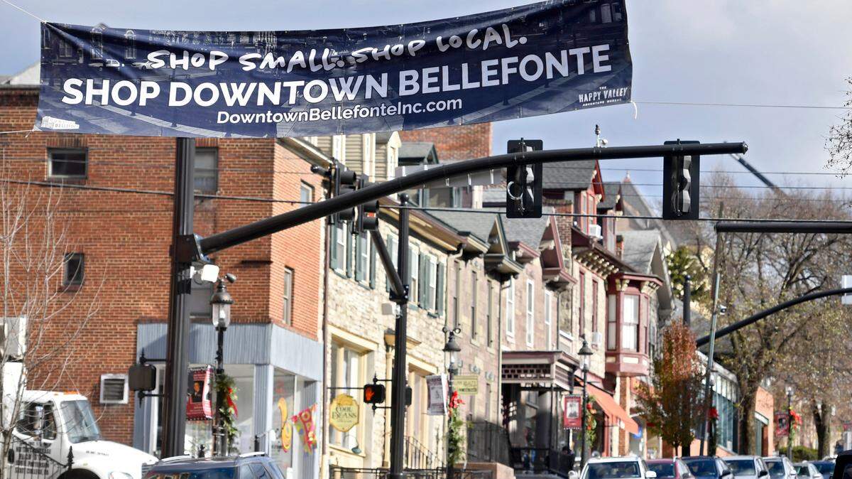 A sign promoting shopping small and local hangs over West High Street in Bellefonte on Tuesday, Nov. 23, 2021.