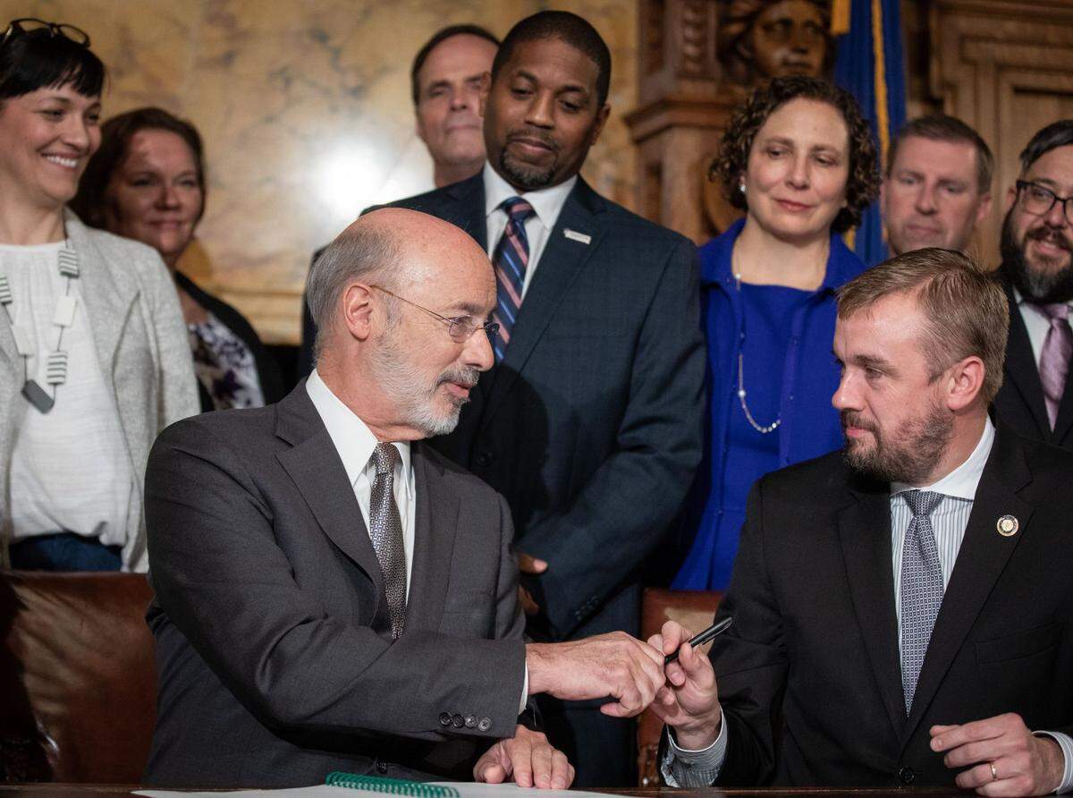 Gov. Tom Wolf and state Rep. Bryan Cutler, R-Lancaster, shook hands after the signing of Act 77.