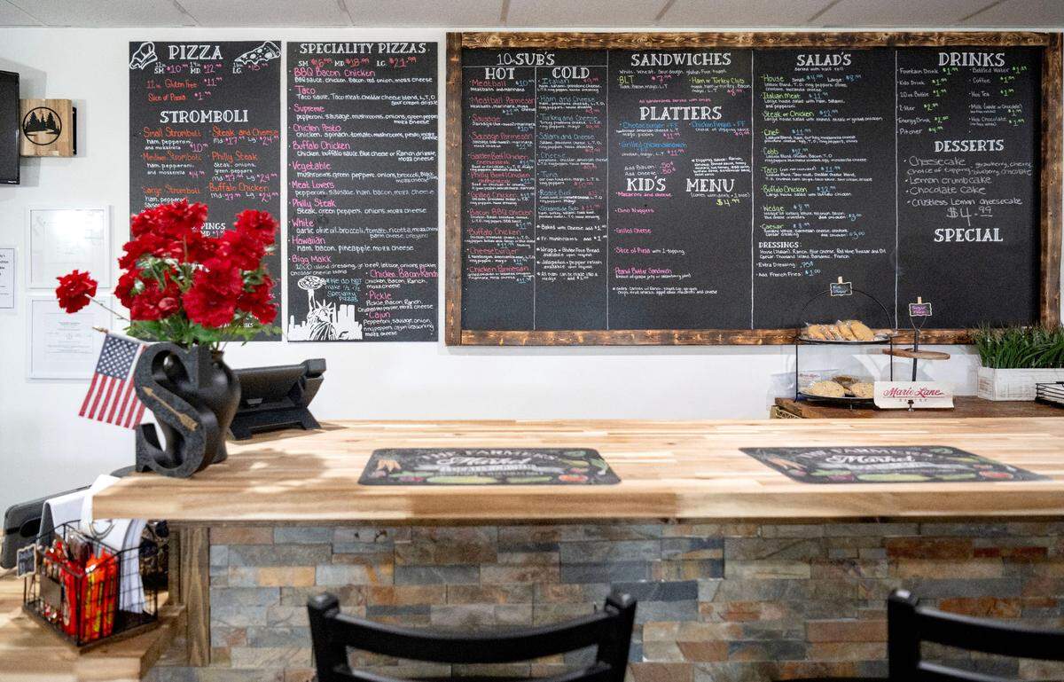 A menu board fills a wall by counter seating at Streamside Family Restaurant’s new location at 2782 Earlystown Road.
