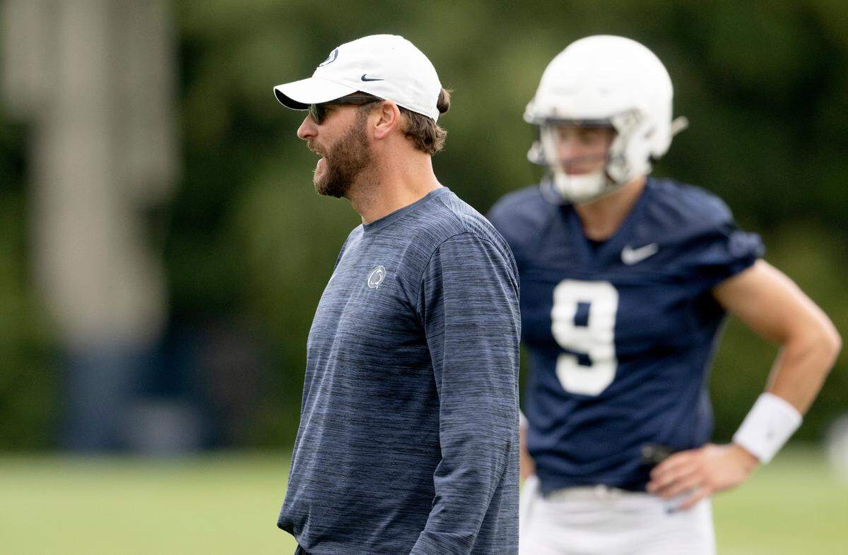 Penn State offensive coordinator Mike Yurcich talks to the quarterbacks during the first day of practice on Monday, Aug. 1, 2022.
