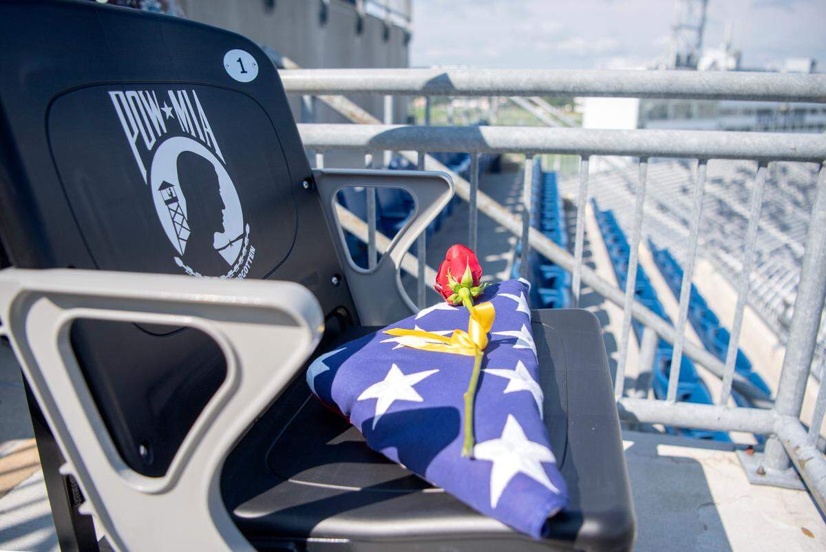 An American flag and a single rose lay on the new POW/MIA Chair of Honor in the south end zone of Beaver Stadium on Wednesday.