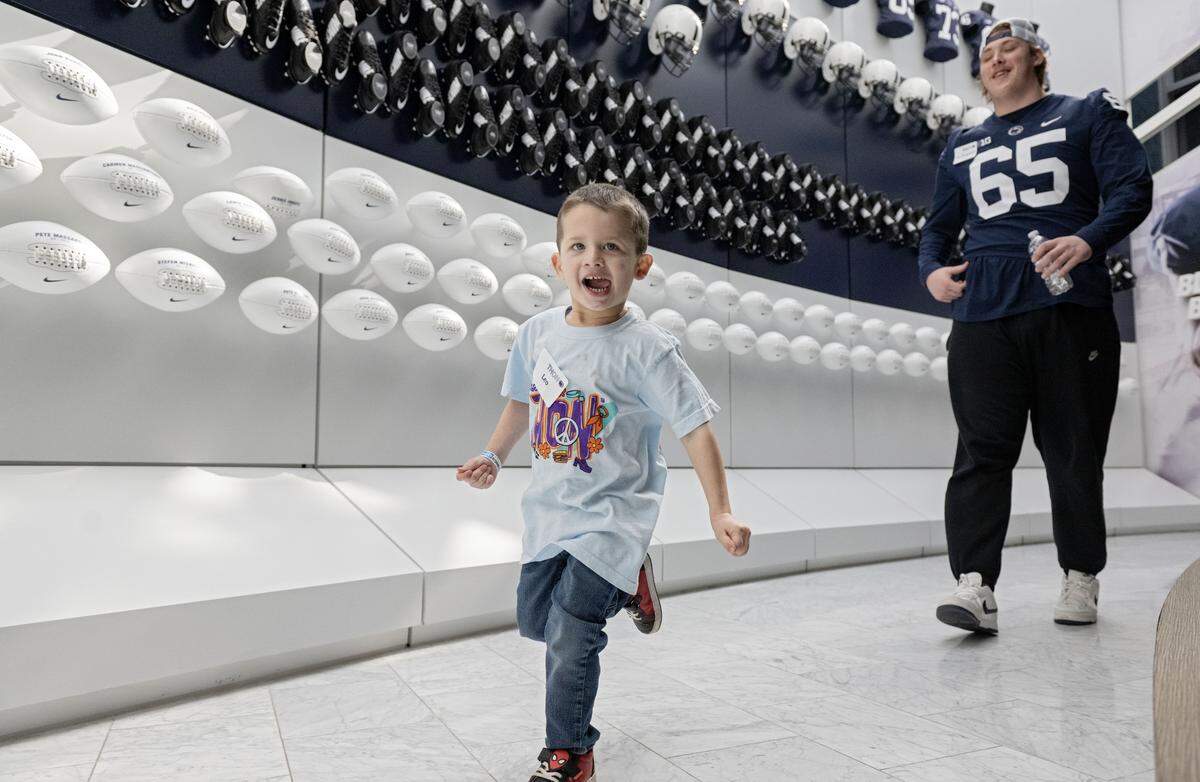 Leo Paese, 3, beats Penn State offensive lineman Jim Fitzgerald in a race during the Thon Explorers event at the Lasch Building on Saturday, Feb. 21, 2026.  