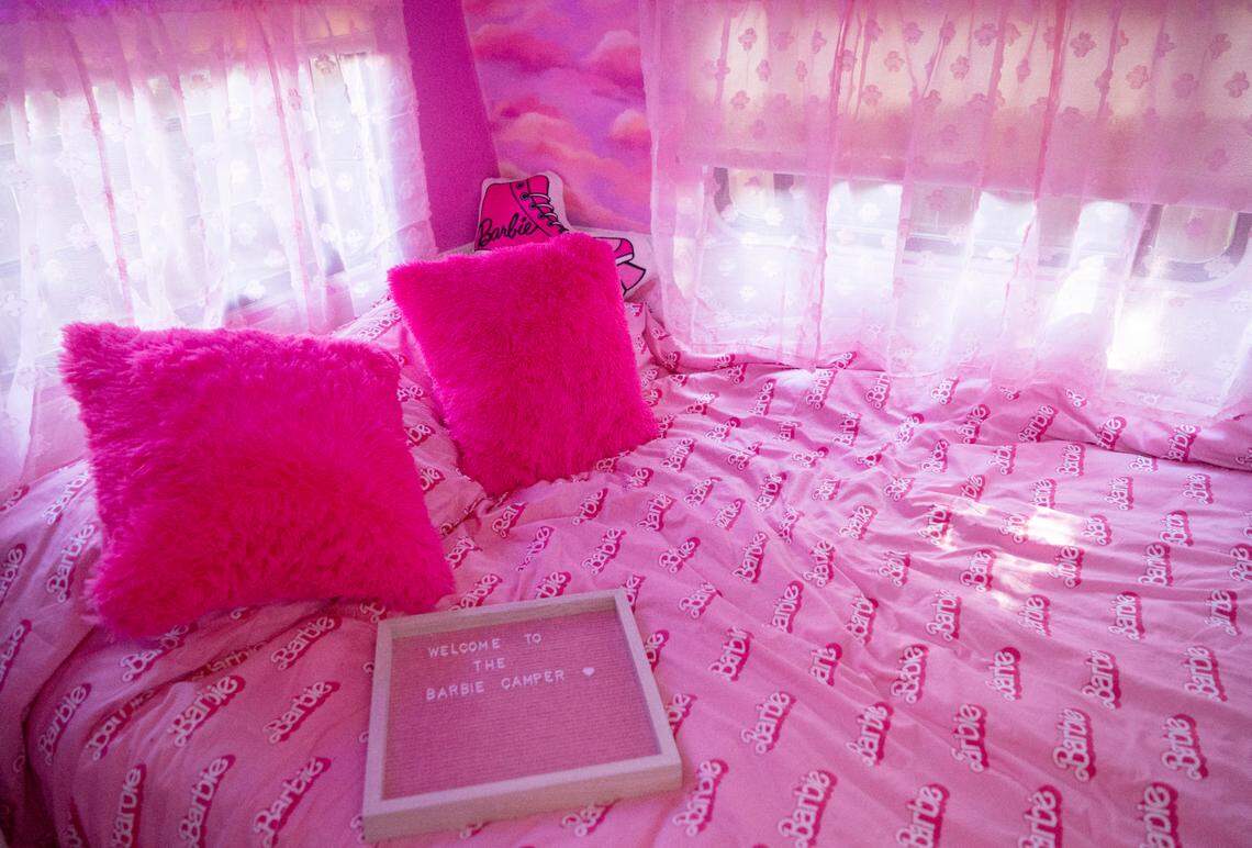 The bedroom of the Barbie camper features pink fuzzy rugs and pillows along with a Barbie comforter.
