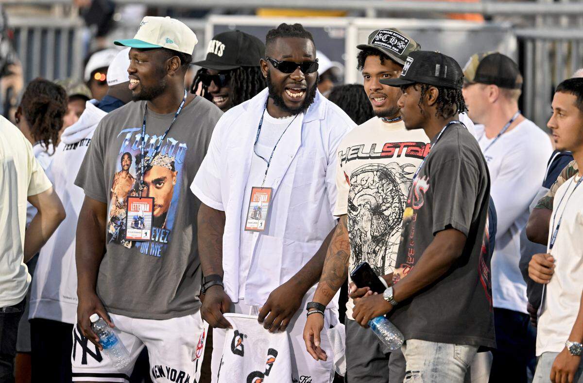 Former Penn State football players and current NFL players Arnold Ebiketie, Jesse Luke, Tariq Castro-Fields and Jahan Dotson chat on the sidelines at Beaver Stadium during the game against West Virginia on Saturday, Sept. 2, 2023.