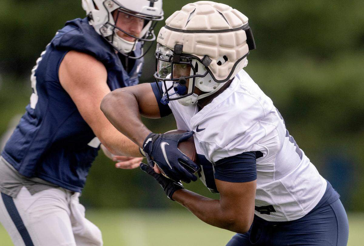 Penn State running back Nicholas Singleton gets the ball during the first day of practice on Monday, Aug. 1, 2022.
