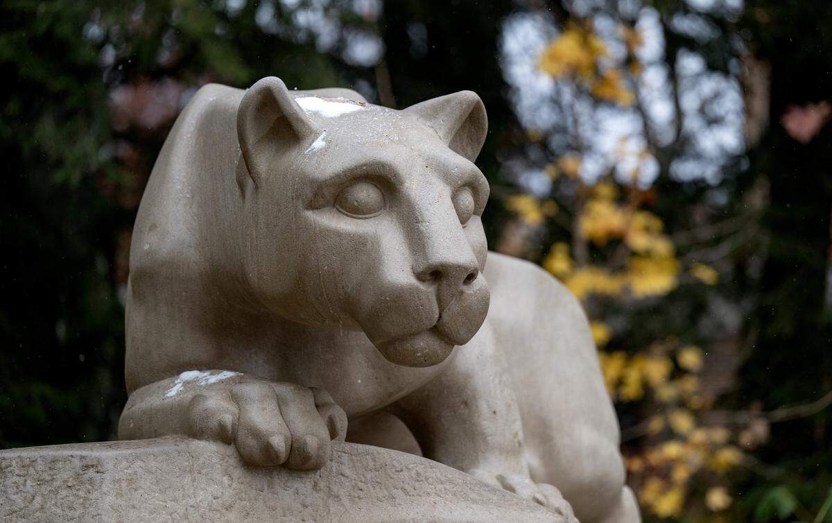 Fall leaves and snow at the Nittany Lion shrine on the Penn State University Park campus on Tuesday, Nov. 11, 2025.  