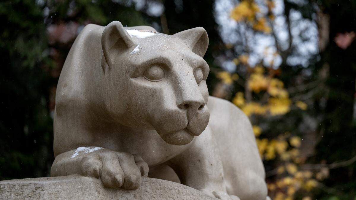 Fall leaves and snow at the Nittany Lion shrine on the Penn State University Park campus on Tuesday, Nov. 11, 2025.