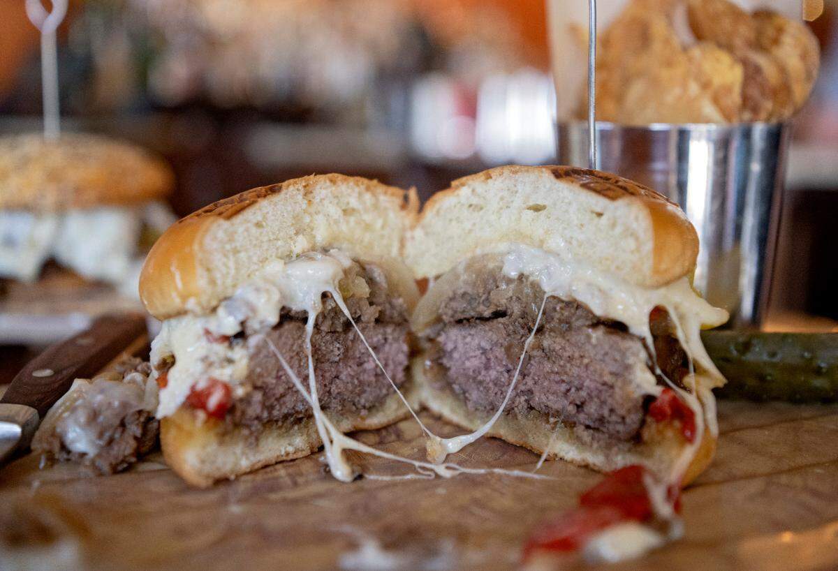 The new Dambach-ery burger, a cheesesteak burger featuring rib eye, caramelized onion, peppers, provolone and roasted garlic parmesan mayo on brioche bun is a new addition on The Field Burger & Tap’s menu.