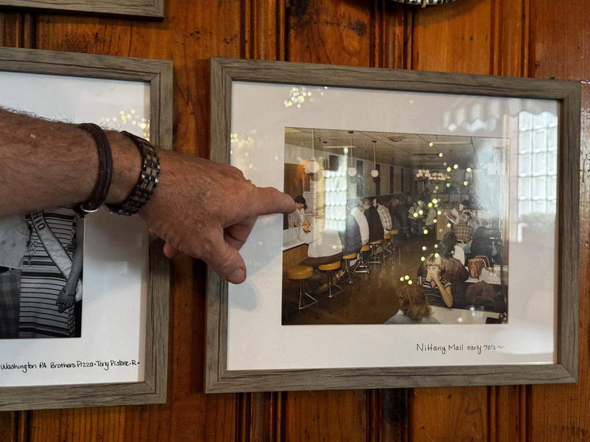 Edward Findley shows off a photo of the Nittany Mall Brothers Pizza hanging in his Snow Shoe shop on June 2, 2026. His wife, Josephine Findley, provided the photo.