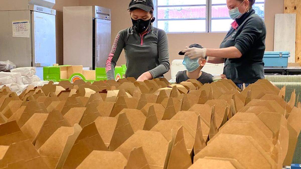 Kat Benajmin, 14, helps to pack preboxed lunches with Joey, 8, and Heather, of Benajamin’s Catering.