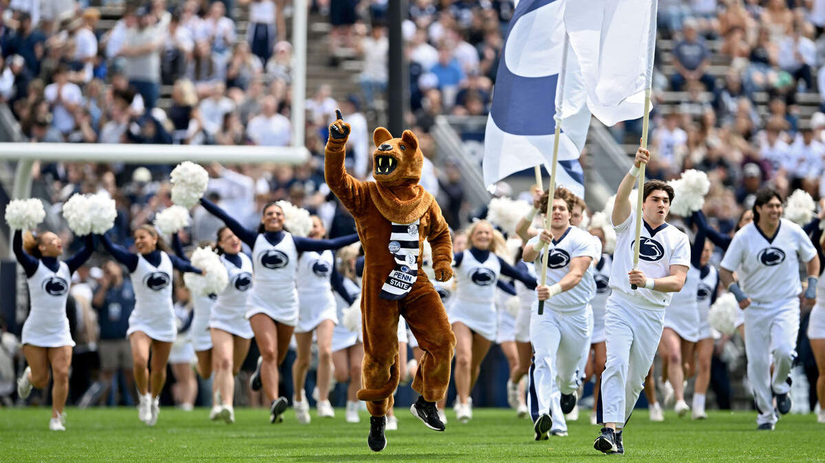 The Penn State Nittany Lion and the cheerleaders run onto the field for the Blue-White game on Saturday, April 26, 2025.  