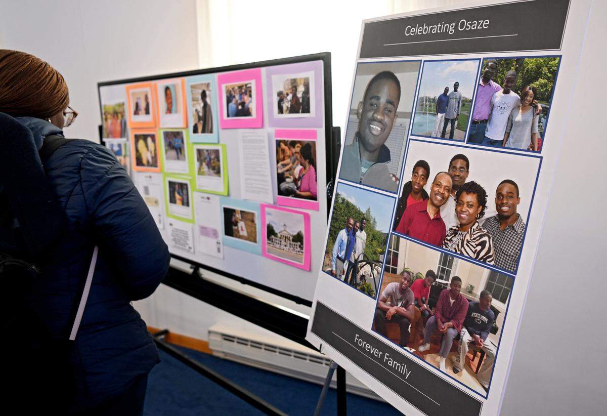 Attendees browse the photos honoring Osaze Osagie during the Osaze’s Heart Scholarship fundraiser dinner on Tuesday, March 19, 2024 at the State College Access Church.