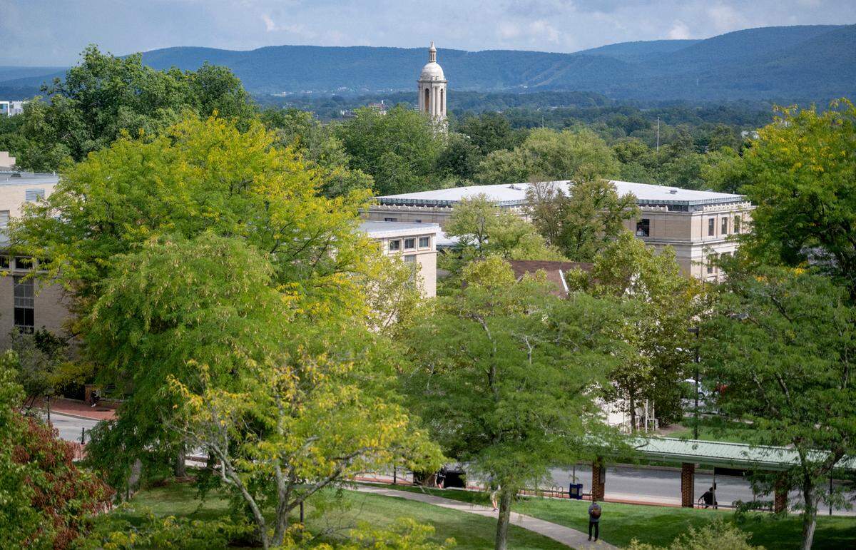 The Old Main bell tower sticks out above the trees on the Penn State campus. The university is the biggest employer in Centre County.